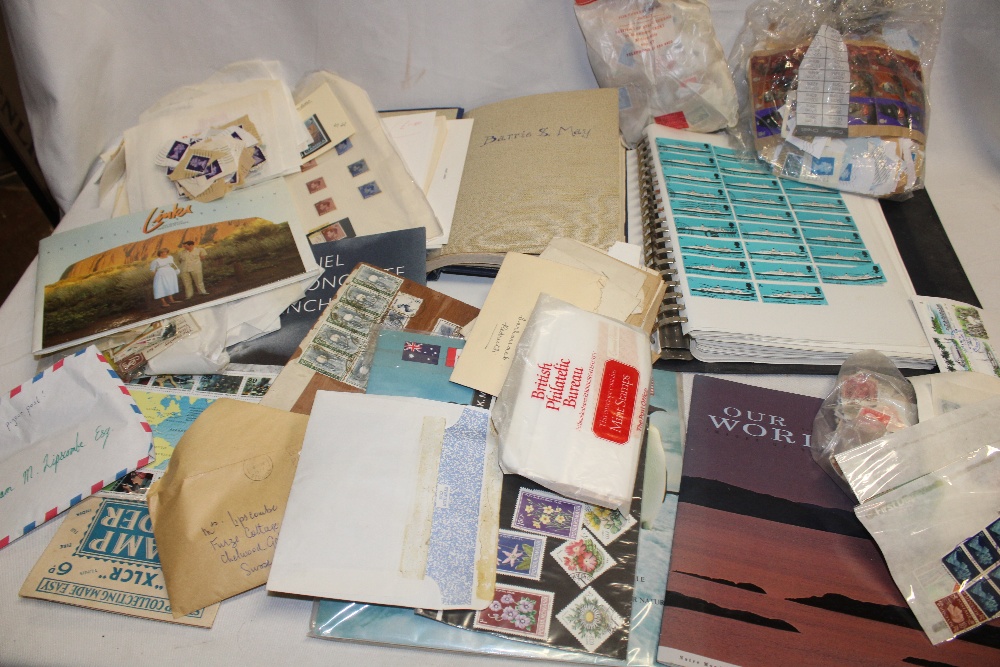 A box containing various packets of World stamps, stamps on/off paper, album leaves of World stamps,