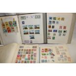 Three albums and a stock book containing a selection of mixed World stamps