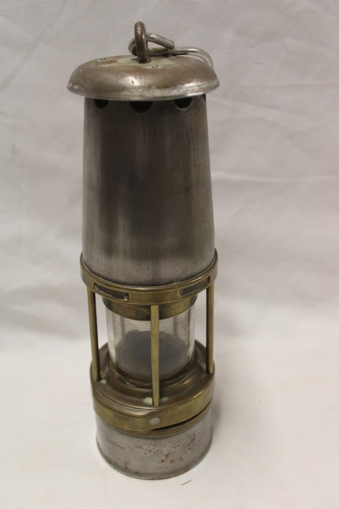 A brass mounted steel Wolf miner's safety lamp by Maurice Ltd.