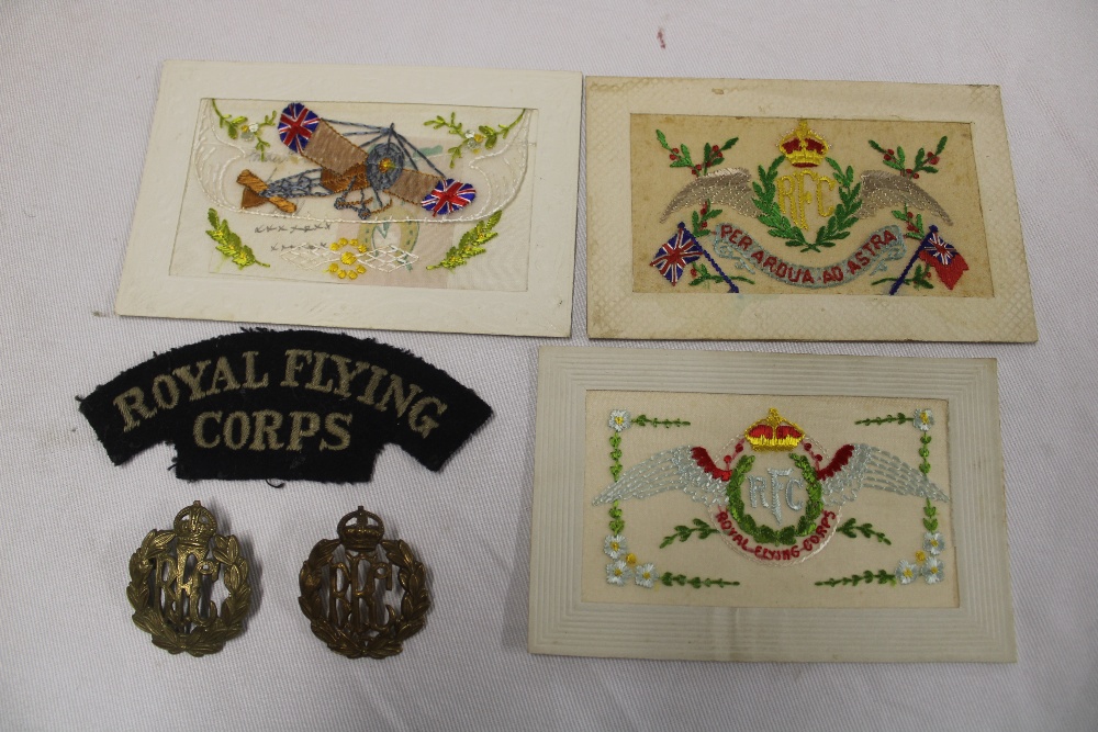 An original First War cloth Royal Flying Corps shoulder title, brass RFC cap badge,