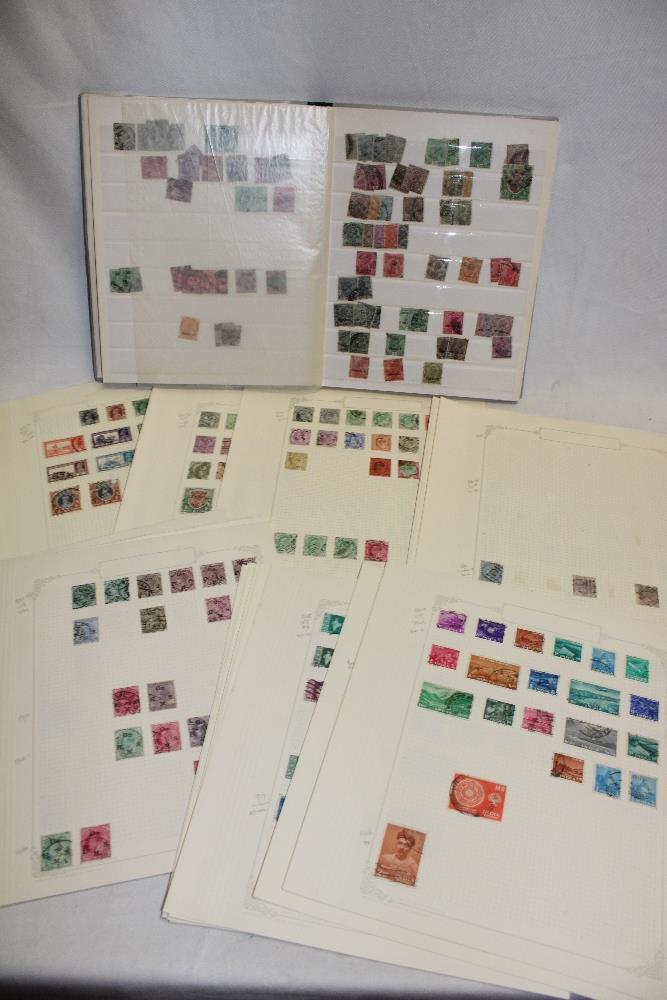 A stock book and various album pages containing a collection of India and Indian States stamps