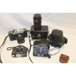 A Rolleiflex SL35 camera together with additional lens and two Rollei B35 cameras