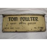 A painted wood advertising sign "Tom Poulter Sheet Metal Worker",