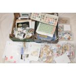 Two boxes containing various packets of World stamps, three albums of mixed World stamps,