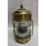 A brass ship's hanging anchor light with ribbed glass lens 10½" high