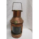 A brass mounted copper cylindrical ship's lamp by Griffiths & Son of Birmingham with oil lamp
