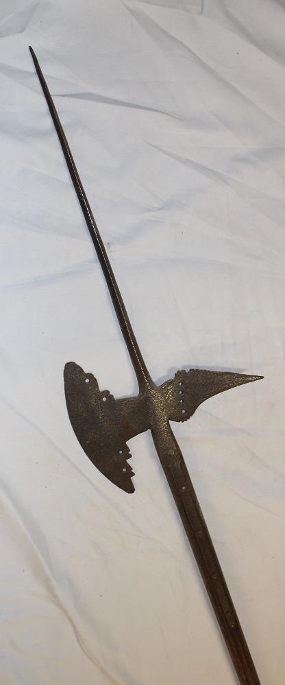 An 18th century iron halberd with 9" curved blade mounted on a later ash shaft 89" long overall