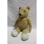 An old plush covered straw filled teddy bear 21" long