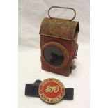 An early GPO Post Office postman's brass arm band and a 1943 GPO oil lamp (2)