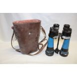 A pair of 7 x Naval binoculars in part leather case