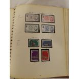 A folder album containing a collection of Guernsey and Jersey mint stamps including German