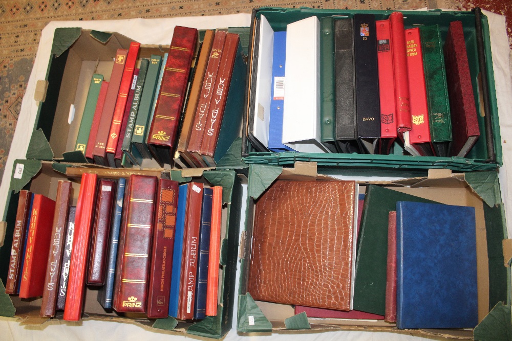 Four boxes containing a large selection of empty stamps albums, stock books etc.