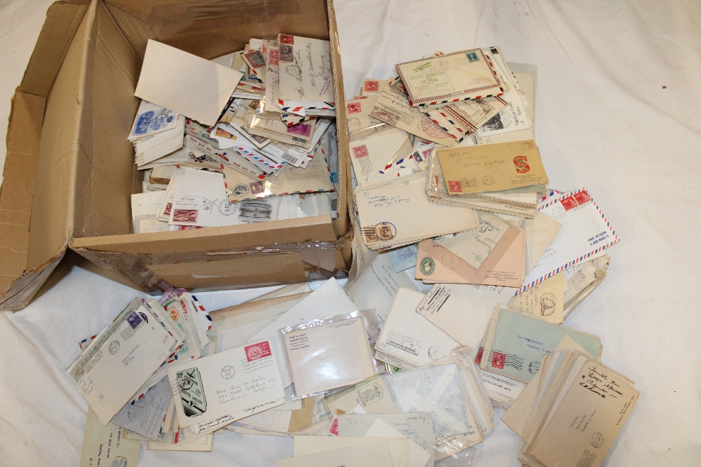 A box containing a large selection of USA postal covers including first flights, postal stationery,