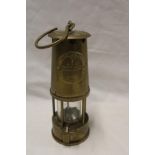 A brass miner's lamp by the Protector Lamp and Lighting Co.
