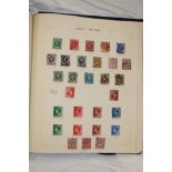 A folder album containing a collection of GB and World stamps,