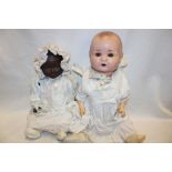 A porcelain headed baby doll by Armand Marseille marked "AM Germany 877K" with composition body and
