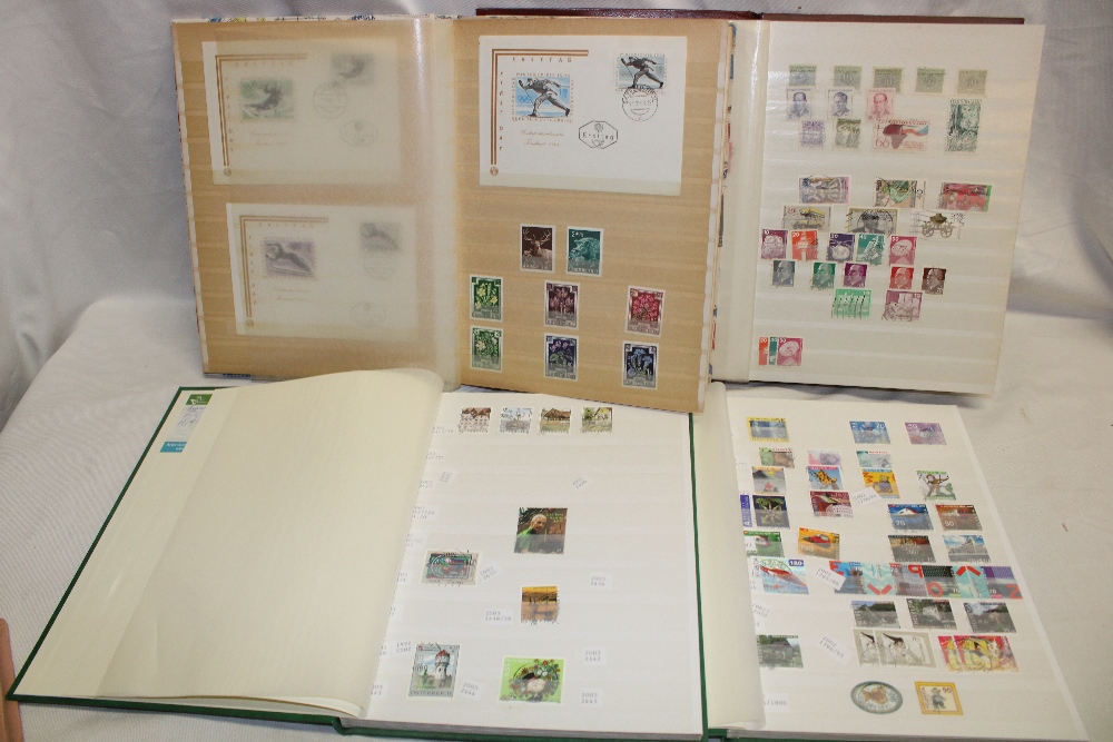 Three stock books containing a collection of Switzerland and Austria stamps together with two other