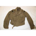A 1952 khaki battle dress blouse with medal ribbons for Korea named to "S908 Walker"