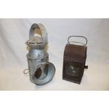 A painted metal hand held railway lantern and one other arched lantern with oil fitment (2)