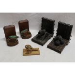 A pair of teak bookends supporting cannon models with bronze barrels 5½" high;