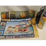 A Matchbox Motorcity G40 boxed racing car set together with street play mat etc.