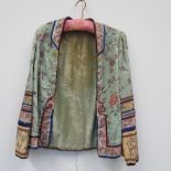 Late 19th/early 20th Century silk jacket, pale blue ground embroidered with stylised Chinese motifs,