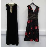 A 1950's black silk cocktail dress with a embossed ruby red floral pattern plain black ruched