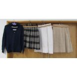 Two ladies kilts and a white skirt,