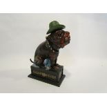 A cast metal money box advertising 'Ole Puffer' dog with cigar