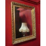 A gilt framed wall mirror with beaded and acanthus design,