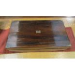 A Victorian rosewood writing box with brass strapping,