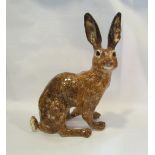 A Winstanley brown seated hare, a/f,