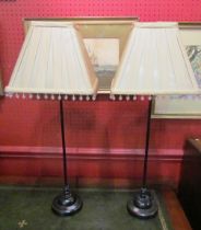 A pair of slender table lamps with silk beaded shades,
