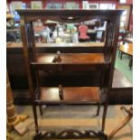 In the manner of 'Liberty & Co' an arts & crafts mahogany two tier book trough with fret work