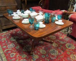 A William IV flame mahogany tilt table the round cornered top on a turned column and outswept