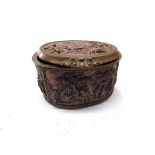 A 19th Century French embossed copper lidded trinket box of oval form with all over figural scenes,