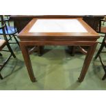 A Chinese elm table with white marble inset,
