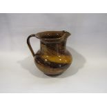 A Victorian glazed pottery jug with tiger stripe effect,