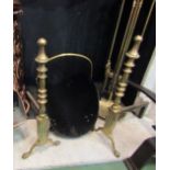 A pair of solid brass fire dogs, ring turned decoration, bird claw feet,