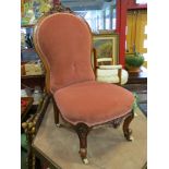 A circa 1850 carved walnut bedroom chair with pink upholstery on scroll feet and white ceramic