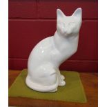 A figure of a white seated cat,
