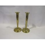 A pair of modernist style brass candlesticks,