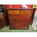 A late Victorian walnut round cornered chest of two short over three graduating long drawers on a