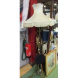 A brass standard lamp on scroll tripod base,