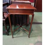 An Edwardian crossbanded mahogany lamp table on pad foot cabriole legs joined by a turned 'x'