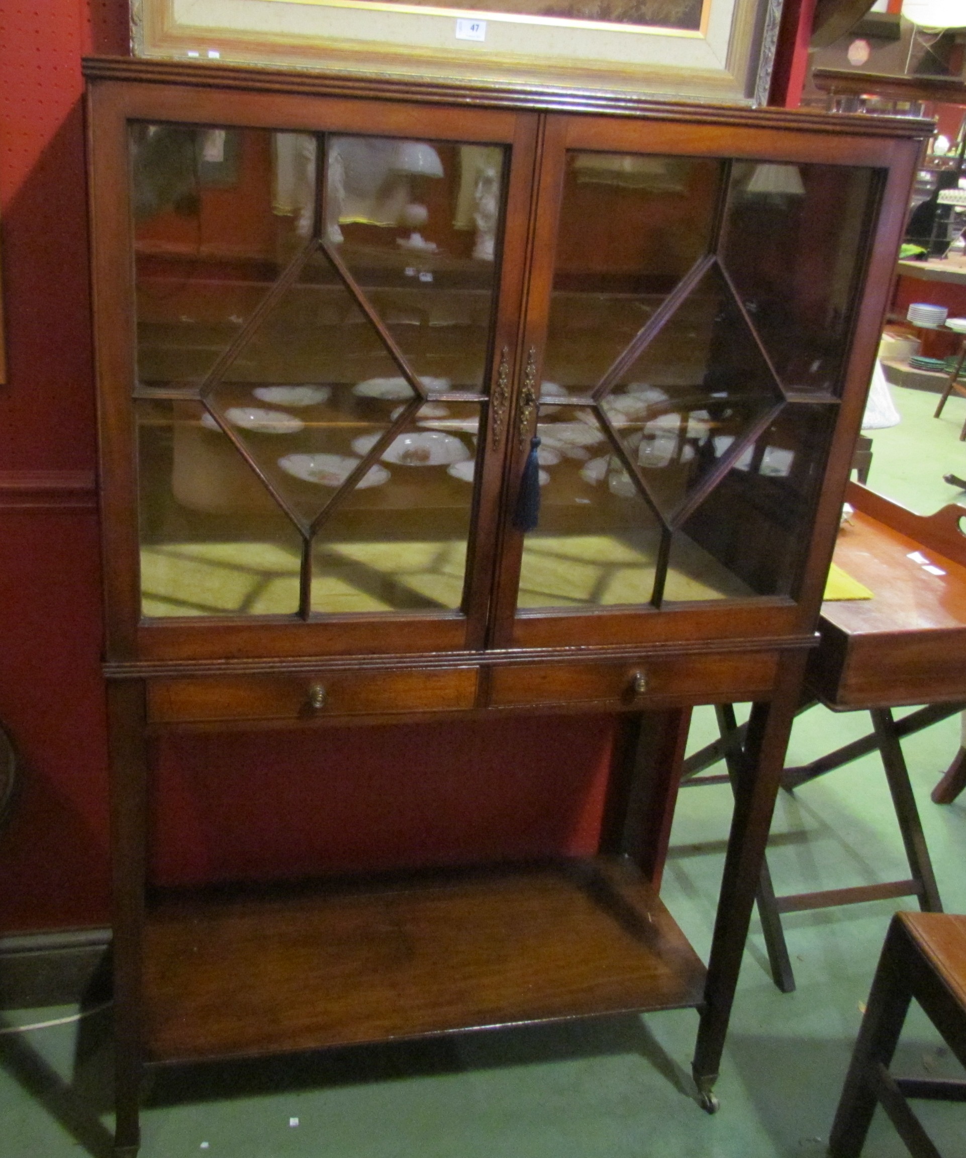 A George III mahogany reeded edge bookcase/cabinet the two astragal glazed doors over two drwers