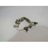 A white metal charm bracelet including silver padlock charm