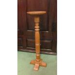 A Cotswold school oak jardiniere stand the circular top on a turned column and sledge foot base,