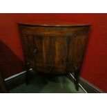 A 19th Century mahogany bow front cabinet the single door cupboard and drawer over sabre lags,