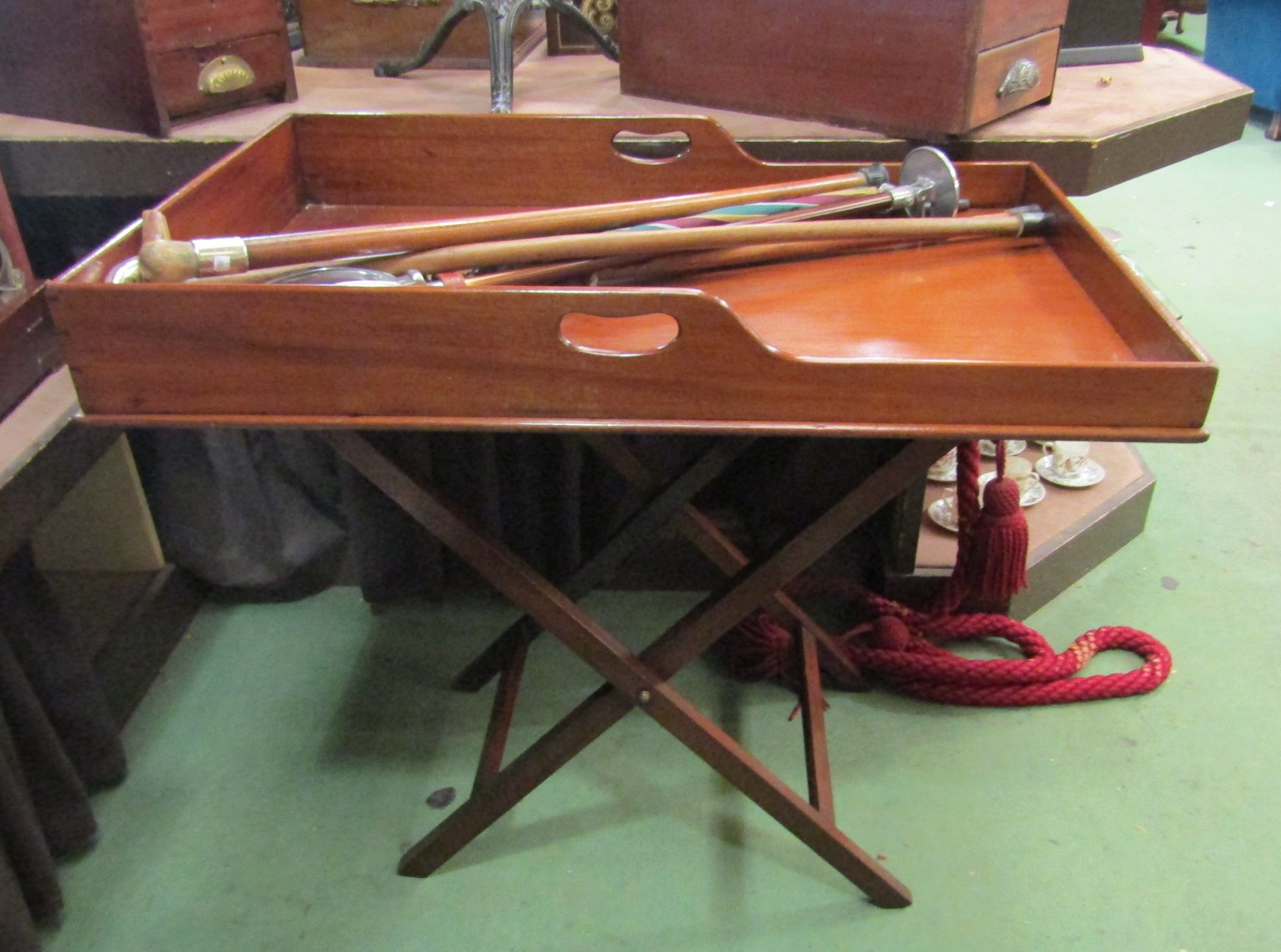 A 19th Century Country House mahogany butler's tray with fret handles on a folding stand